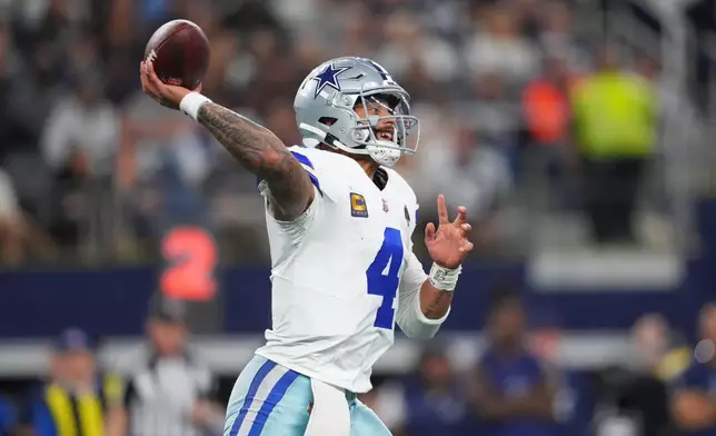 Dallas Cowboys quarterback Dak Prescott throws a pass during the first half of an NFL football game against the Minnesota Vikings Sunday, Dec. 14, 2025, in Arlington, Texas. (AP Photo/Julio Cortez)