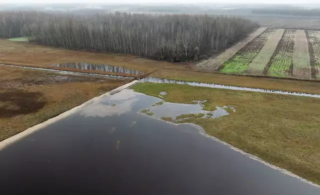 Water floods an area and an artificial lake in Kiskunmajsa, Hungary, Tuesday, July 29, 2025. (AP Photo/Denes Erdos)