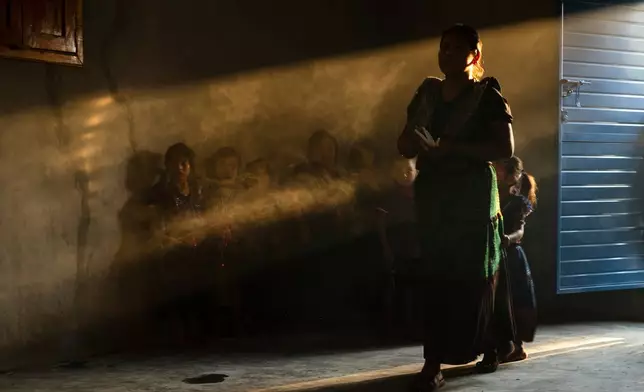 Congregants attend an Indigenous blessing ceremony for Communion wafers that will be taken to a priest to be consecrated before they can be given out, in the Simojovel municipality of Mexico, April 26, 2025. (AP Photo/Isabel Mateos, File)