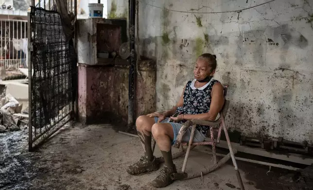 Angela Perez sits inside her flood-damaged house in Poza Rica, Veracruz state, Mexico, Oct. 15, 2025, one of the areas hardest hit by torrential rains that flooded central and eastern Mexico. (AP Photo/Felix Marquez, File)