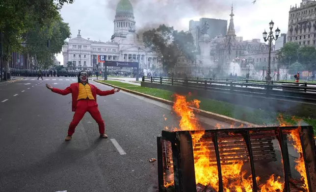 A protester in a Joker costume takes part in a demonstration by soccer fans and retirees demanding higher pensions and opposing austerity measures implemented by President Javier Milei's government in Buenos Aires, Argentina, March 12, 2025. (AP Photo/Rodrigo Abd, File)