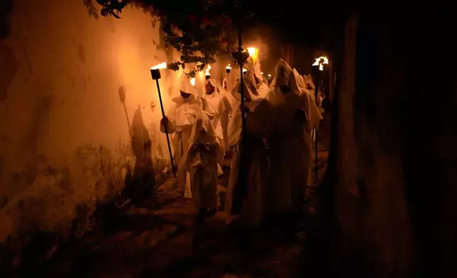 Penitents take part in the Holy Week Procession of Souls in Goias, Brazil, April 17, 2025. (AP Photo/Eraldo Peres, File)