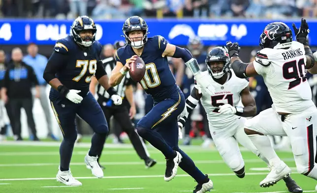 Los Angeles Chargers quarterback Justin Herbert (10) runs with the ball during the first half of an NFL football game against the Houston Texans Saturday, Dec. 27, 2025, in Inglewood, Calif. (AP Photo/Wally Skalij)