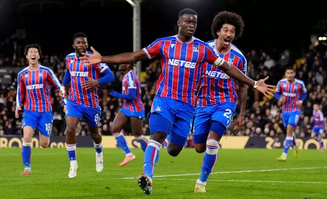 Crystal Palace's Marc Guehi celebrates after scoring his sides second goal during the English Premier League soccer match between Fulham and Crystal Palace, in London, Sunday, Dec. 7, 2025. (John Walton/PA via AP)