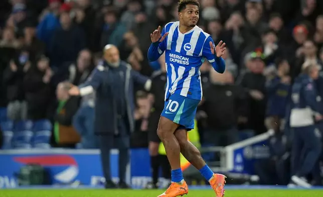 Brighton and Hove Albion's Georginio Rutter celebrates after scoring his sides first goal during the English Premier League soccer match between Brighton and Hove Albion v West Ham United, in Brighton, England, Sunday, Dec. 7, 2025. (Gareth Fuller/PA via AP)