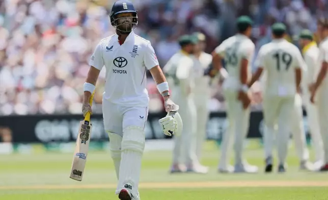 England's Ben Duckett walks from the field after he was dismissed during play on day four of the third Ashes cricket test between England and Australia in Adelaide, Australia, Saturday, Dec. 20, 2025. (AP Photo/James Elsby)