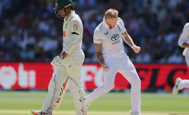 England's Ben Stokes, right, celebrates after dismissing Australia's Alex Carey, left, during play on day four of the third Ashes cricket test between England and Australia in Adelaide, Australia, Saturday, Dec. 20, 2025. (AP Photo/James Elsby)