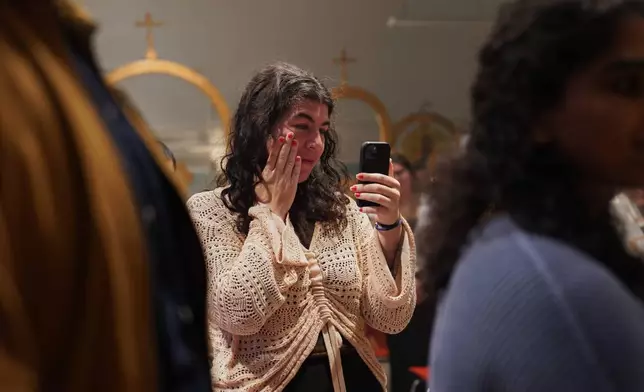 Members of St. Moses the Black Orthodox Church worship together during service on Sunday, Nov. 9, 2025, in Pittsburgh. (AP Photo/Jessie Wardarski)