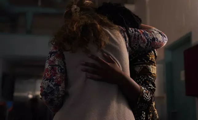 Andrea Danko-Barna, left, hugs Fidelia Gaba, a University of Pittsburgh medical student and Orthodox convert, during Gaba's chrismation service, in which she was confirmed as a member of St. Moses the Black Orthodox Church, Sunday, Nov. 9, 2025, in Pittsburgh. (AP Photo/Jessie Wardarski)