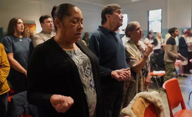 Members of St. Moses the Black Orthodox Church worship together during service on Sunday, Nov. 9, 2025, in Pittsburgh. (AP Photo/Jessie Wardarski)