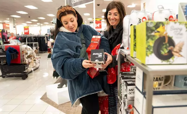 FILE - Becca Mendoza and Tammi Hines look at products as shoppers browse through Kohl's department store for Black Friday deals, Friday, Nov. 28, 2025, in Woodstock, Ga. (AP Photo/Megan Varner, File)