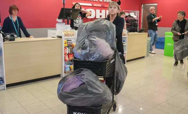 FILE - A shopper loads a cart full at Kohl's department store for Black Friday deals, Friday, Nov. 28, 2025, in Woodstock, Ga. (AP Photo/Megan Varner, File)