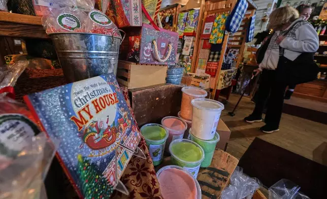 Post-holiday shoppers pass a seasonal candy and Christmas display at Calef's Country Store, Friday, Dec. 26, 2025, in Barrington, N.H. (AP Photo/Charles Krupa)