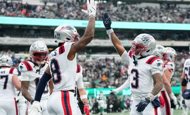 New England Patriots wide receiver Stefon Diggs (8) celebrates after a touchdown against the New York Jets with teammate Demario Douglas (3) during the first half of an NFL football game, Sunday, Dec. 28, 2025, in East Rutherford, N.J. (AP Photo/Frank Franklin)