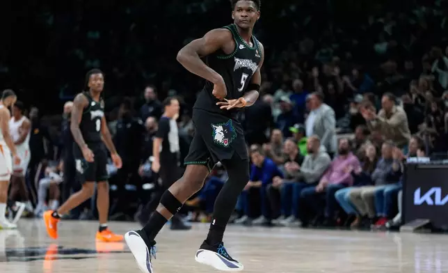 Minnesota Timberwolves guard Anthony Edwards (5) celebrates after making a shot during the second half of an NBA basketball game against the Phoenix Suns, Monday, Dec. 8, 2025, in Minneapolis. (AP Photo/Abbie Parr)