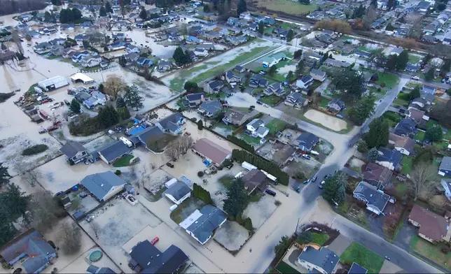 This image made from a video provided by the Pacific Police Department shows homes underwater, Tuesday, Dec. 16, 2025, in Pacific, Wash. (Pacific Police Department via AP)