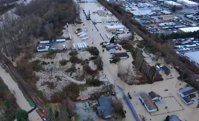 This image made from a video provided by the Pacific Police Department shows homes and buildings underwater, Tuesday, Dec. 16, 2025, in Pacific, Wash. (Pacific Police Department via AP)