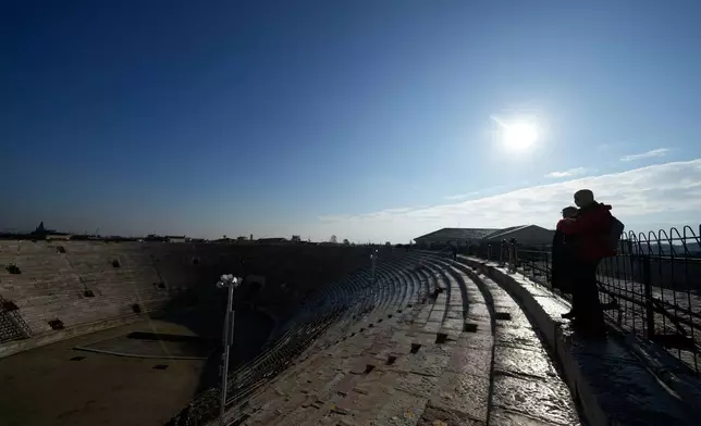 Visitors watch from the last ring at the Arena of Verona, Italy, Wednesday, Dec. 10, 2025. (AP Photo/Luca Bruno)