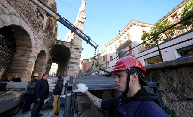 Workers build walkways for disabled access at the Arena of Verona, Italy, Wednesday, Dec. 10, 2025. (AP Photo/Luca Bruno)