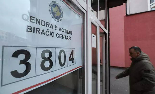 A voter arrives at a polling station in an early parliamentary election in the northern Serb-dominated part of ethnically divided town of Mitrovica, Kosovo, Sunday, Dec. 28, 2025. (AP Photo/Bojan Slavkovic)