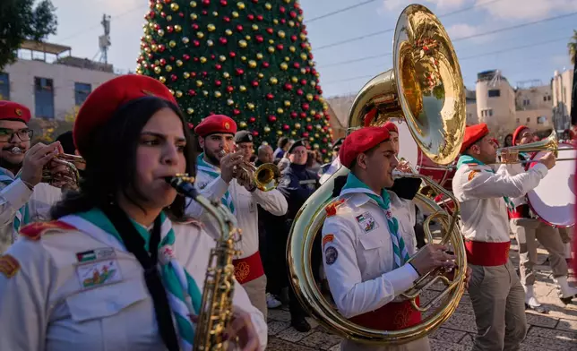 Palestinian scout bands parade at the Manger Square near the Church of the Nativity, traditionally believed to be the birthplace of Jesus, on Christmas Eve, in the West Bank city of Bethlehem, Wednesday, Dec. 24, 2025. (AP Photo/Nasser Nasser)