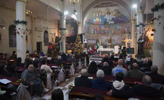 Palestinian Christians attend Mass on Christmas Eve at the Holy Family Catholic Church in Gaza City, Wednesday, Dec. 24, 2025. (AP Photo/Jehad Alshrafi)