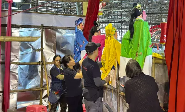 The puppeteers behind the stage, Photo by Bastille Post