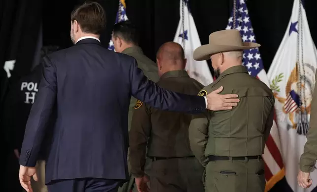 Vice President JD Vance walks out with Federal law enforcement agents after a news conference on Thursday, Jan. 22, 2026, in Minneapolis. (AP Photo/Angelina Katsanis)