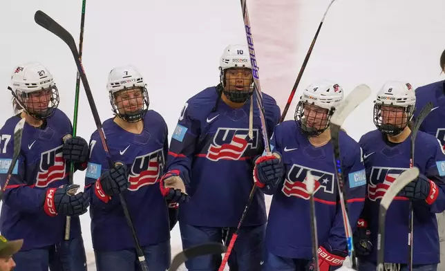 FILE - US's Taylor Heise (27), Lacey Eden (7), Laila Edwards (10) Caroline Harvey (4) and Haley Winn (8) celebrate with teammates after the US defeated Canada in a Rivalry Series women's hockey game Thursday, Nov. 6, 2025, in Cleveland. (AP Photo/Sue Ogrocki, File)