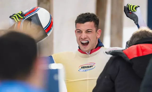 Winner Matt Weston of Great Britain celebrates after the Men's Skeleton World Cup in St. Moritz, Switzerland, Friday, Jan. 9, 2026. (Mayk Wendt/Keystone via AP)
