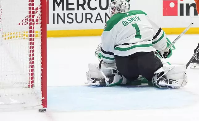 Dallas Stars goaltender Casey DeSmith turns around to see a shot by Anaheim Ducks center Mason McTavish go wide of the goal during the first period of an NHL hockey game Tuesday, Jan. 13, 2026, in Anaheim, Calif. (AP Photo/Gregory Bull)