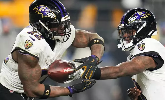 Baltimore Ravens quarterback Lamar Jackson, right, hands the ball off to running back Derrick Henry (22) during the first half of an NFL football game against the Pittsburgh Steelers, Sunday, Jan. 4, 2026, in Pittsburgh. (AP Photo/Gene J. Puskar)