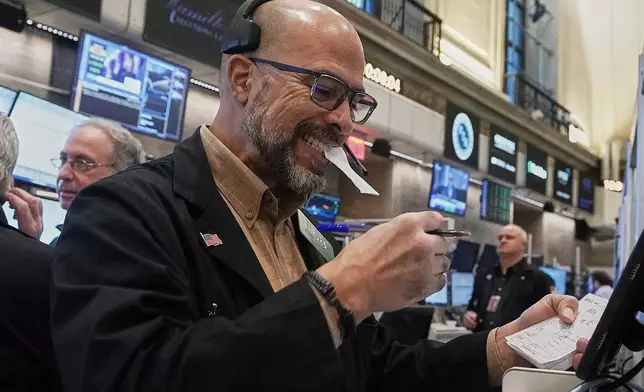 Options trader Steven Rodriguez works on the floor of the New York Stock Exchange, Thursday, Jan. 8, 2026. (AP Photo/Richard Drew)