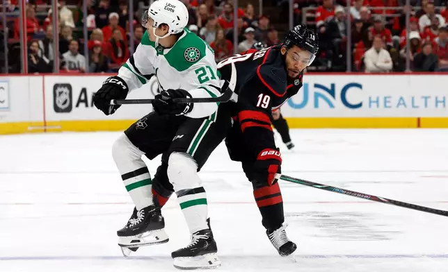 Carolina Hurricanes' K'andre Miller (19) collides with Dallas Stars' Jason Robertson (21) during the first period of an NHL hockey game in Raleigh, N.C., Tuesday, Jan. 6, 2026. (AP Photo/Karl DeBlaker)