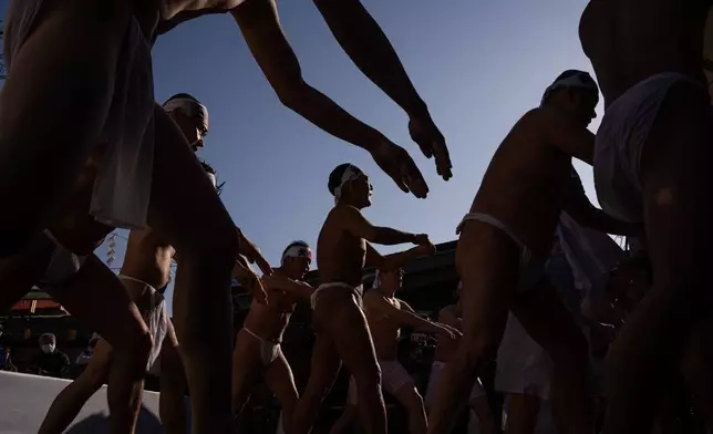 Participants pray after pouring cold water over themselves to purify their souls and wish for good health during a New Year's ritual at Kanda Myojin Shrine in Tokyo, Saturday, Jan. 17, 2026. (AP Photo/Louise Delmotte)