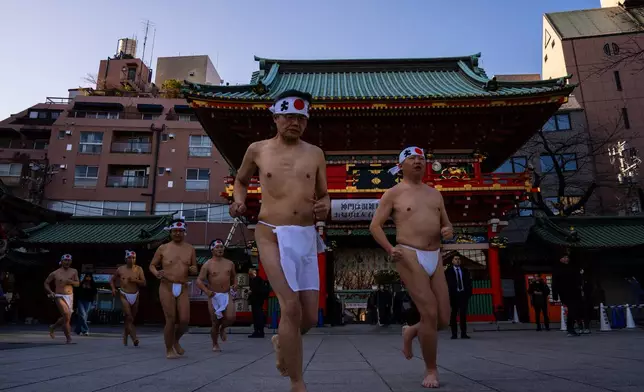 Participants prepare to bathe in ice-cold water to purify their souls and pray for good health during a New Year's ritual at Kanda Myojin Shrine in Tokyo, Saturday, Jan. 17, 2026. (AP Photo/Louise Delmotte)