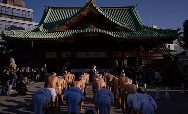 Participants prepare to bathe in ice-cold water to purify their souls and pray for good health during a New Year's ritual at Kanda Myojin Shrine in Tokyo, Saturday, Jan. 17, 2026. (AP Photo/Louise Delmotte)