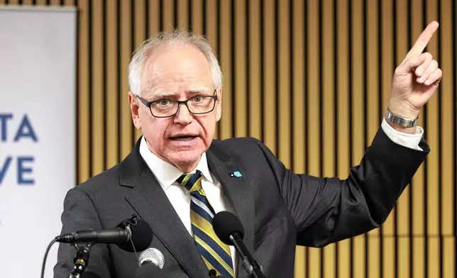 Minnesota Gov. Tim Walz responds to questions from reporters regarding whether he will seek a third term during a press conference following an event on the state's new Paid Family and Medical Leave program, Tuesday, Jan. 6, 2026, in Minneapolis. (Kerem Yücel/Minnesota Public Radio via AP)
