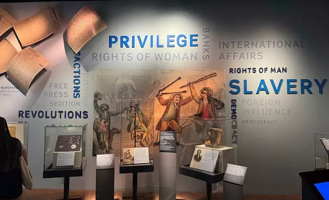 FILE - A display in the "Great Debate" section of a democracy exhibit at the National Museum of American History, seen Aug. 26, 2025, in Washington, reflects some of the issues the nation grapples with. (AP Photo/Calvin Woodward, File)