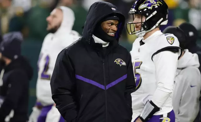 Baltimore Ravens quarterback Lamar Jackson watches on the field during pre-game warm ups before an NFL football game against the Green Bay Packers, Saturday, Dec. 27, 2025, in Green Bay, Wis. (AP Photo/Matt Ludtke)