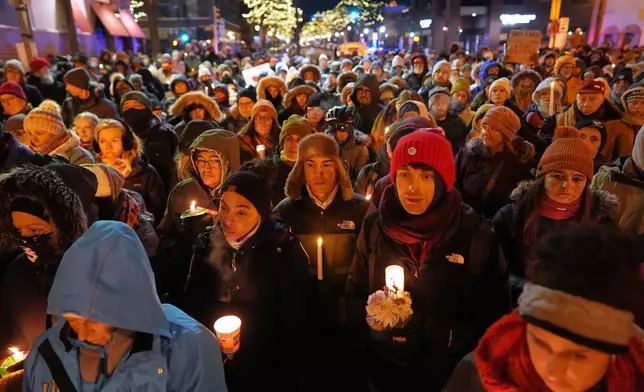 People gather during a vigil where Alex Pretti was shot and killed by federal immigration enforcement in Minneapolis, on Wednesday, Jan. 28, 2026. (AP Photo/Adam Gray)