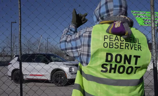 A protester yells at a vehicle at Bishop Whipple Federal building in Minneapolis on Wednesday, Jan. 28, 2026. (AP Photo/Laura Bargfeld)