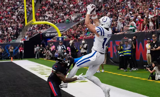 Indianapolis Colts wide receiver Alec Pierce (14) is defended by Houston Texans cornerback Ja'marcus Ingram (42) as he fails to make a catch in the end zone during the second half of an NFL football game in Houston, Sunday, Jan. 4, 2026. (AP Photo/David J. Phillip)