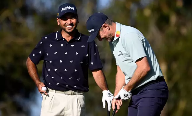 Justin Rose, right, of England, and Jason Day, of Australia, smile after Rose hit his tee shot on the ninth hole on the North Course at Torrey Pines during the first round of the Farmers Insurance Open golf tournament Thursday, Jan. 29, 2026, in San Diego. (AP Photo/Denis Poroy)