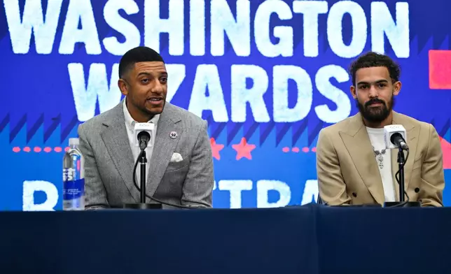 Washington Wizards general manager Will Dawkins, left, introduces newly acquired point guard Trae Young, right, at a news conference before an NBA basketball game against the New Orleans Pelicans, Friday, Jan. 9, 2026, in Washington. (AP Photo/John McDonnell)
