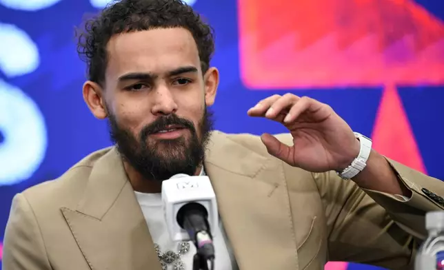 Washington Wizards newly acquired point guard Trae Young answers a question at news conference before an NBA basketball game against the New Orleans Pelicans, Friday, Jan. 9, 2026, in Washington. (AP Photo/John McDonnell)