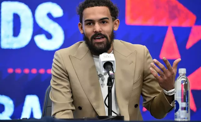 Washington Wizards newly acquired point guard Trae Young answers a question at news conference before an NBA basketball game against the New Orleans Pelicans, Friday, Jan. 9, 2026, in Washington. (AP Photo/John McDonnell)