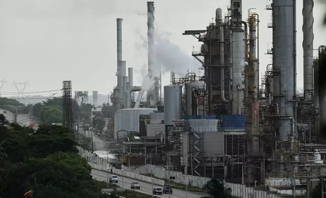 FILE - Vehicles drive past the El Palito oil refinery in Puerto Cabello, Venezuela, Dec. 21, 2025. (AP Photo/Matias Delacroix, File)
