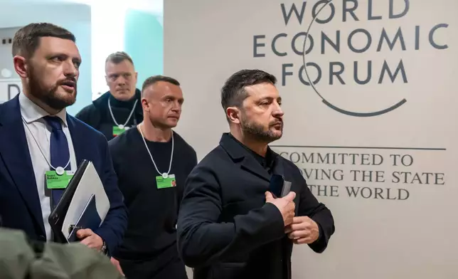 Ukraine's President Volodymyr Zelenskyy, right, arrives for the Annual Meeting of the World Economic Forum in Davos, Switzerland, Thursday, Jan. 22, 2026. (Laurent Gillieron/Keystone via AP)