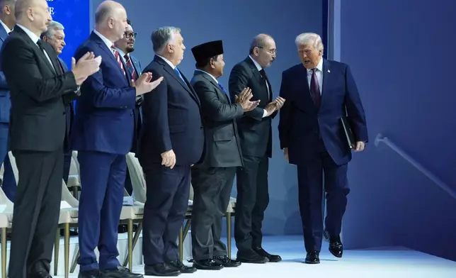 President Donald Trump arrives for a Board of Peace charter announcement during the Annual Meeting of the World Economic Forum in Davos, Switzerland, Thursday, Jan. 22, 2026. (AP Photo/Evan Vucci)